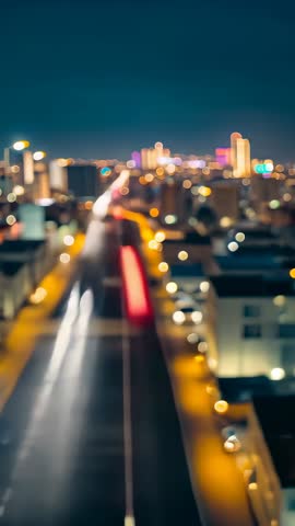 Creating neon light trails along avenue at night | Vertical cityscape motion blur video