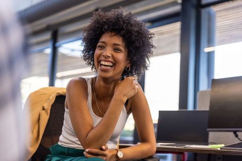 Happy young professional in modern office environment