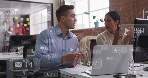Team Collaborating on Project in Open-Plan Office, Discussing Laptop Documents and Strategy