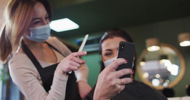 Hairdresser Showing Style to Client on Phone for Hair Transformation - Download Free Stock Images Pikwizard.com