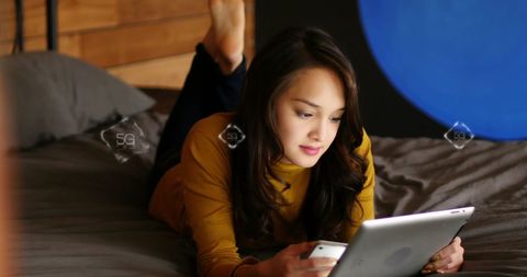 Young woman using tablet and smartphone technology at home