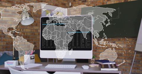 Creative workspace with world map and code on monitor display