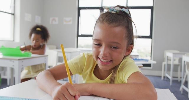 Smiling Girl Writing in Classroom during School Activity - Download Free Stock Images Pikwizard.com