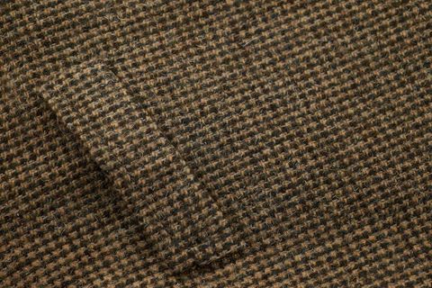 Showcasing brown houndstooth wool tweed fabric texture for fashion and interiors