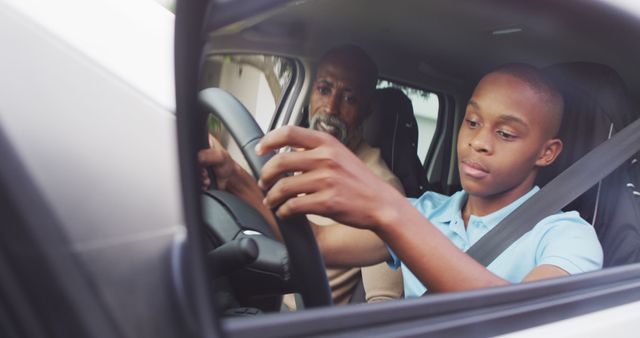 Teenage boy practicing driving under the guidance of an adult in a car interior. Concept of driving education, safety, and mentor guidance. Useful for content related to drivers' education, safety campaigns, skill development, and family activities.