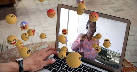 Virtual Meeting with Emotive Floating Emojis on Laptop Screen