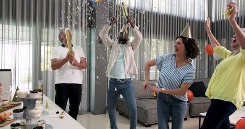 Diverse Team Celebrating with Fun and Confetti in Office Lounge