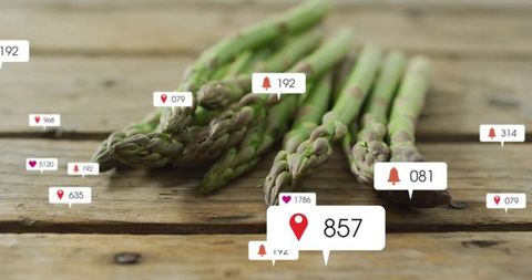 Fresh Asparagus with Social Media Notification Icons on rustic table