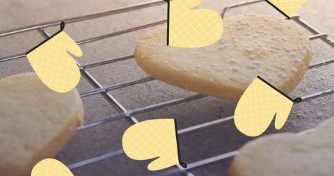Heart-shaped cookies cooling on rack with fun mittens overlay - Download Free Stock Images Pikwizard.com