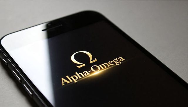 Black smartphone displaying gold alpha-omega logo with glossy reflection and minimalist luxury