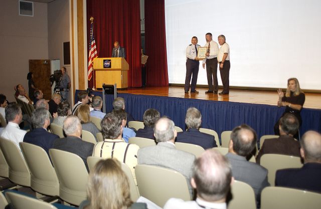 Brig. Gen. J. Gregory Pavlovich (left), 45th Space Wing, and Center Director Jim Kennedy (right) present one of several individual safety awards given on Spaceport Super Safety and Health Day.  An annual event at KSC and Cape Canaveral Air Force Station,  Spaceport Super Safety and Health Day is dedicated to reinforcing safe and healthful behaviors in the workforce.