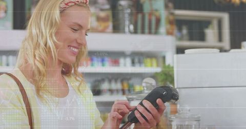 Smiling Woman Processing Payment in Modern Cafe