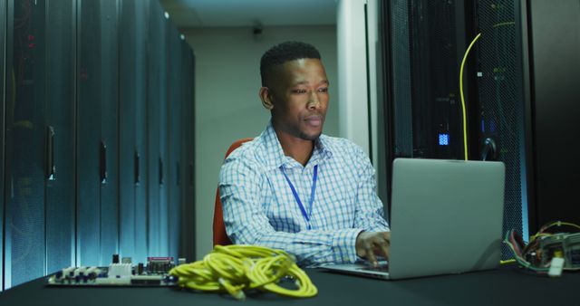 IT Specialist Working on Laptop in Data Center - Download Free Stock Photos Pikwizard.com