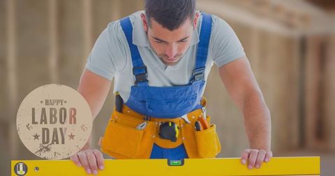 Caucasian Male Construction Worker with Spirit Level Labor Day Concept - Download Free Stock Images Pikwizard.com
