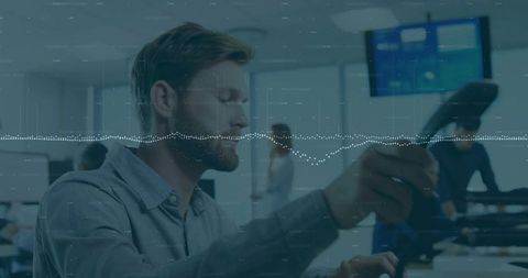 Bearded Man Handling Support Call in Modern Office Environment