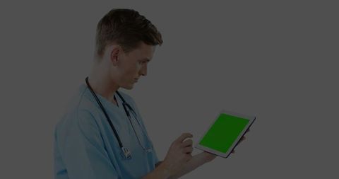 Male Medical Professional Using Tablet with Green Screen