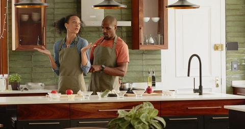 Couple Cooking Together having Fun in Beautiful Kitchen