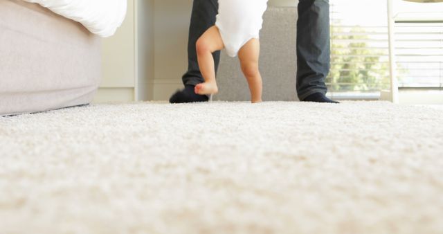 Baby Taking First Steps with Support from Parent in Cozy Home - Download Free Stock Images Pikwizard.com