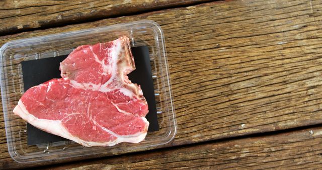 Raw Beef Steak in Packaging on Wooden Table - Download Free Stock Images Pikwizard.com