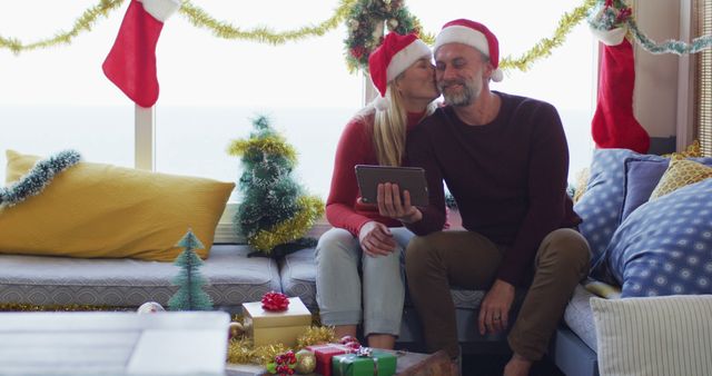 Couple Celebrating Christmas Together with Tablet in Festive Living Room - Download Free Stock Images Pikwizard.com