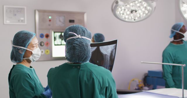 Diverse surgeons with face masks inspecting xray in hospital - Download Free Stock Photos Pikwizard.com