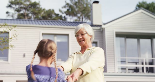 Happy Grandmother Playing with Granddaughter Outdoors in Sunny Backyard - Download Free Stock Images Pikwizard.com