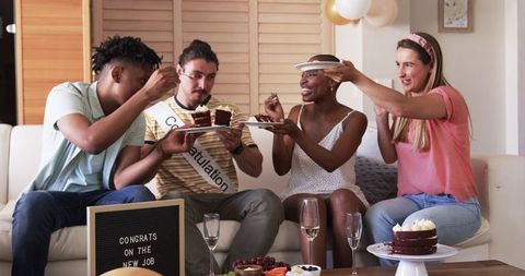 Friends Celebrating New Job with Cake in Cozy Living Room