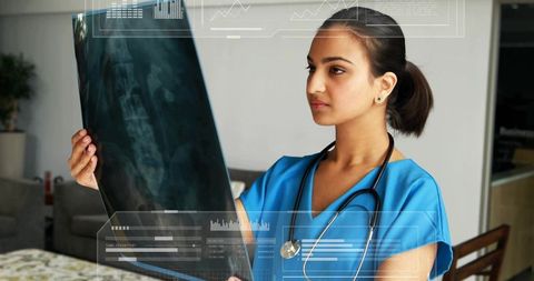 Female Doctor Analyzing Spinal X-ray in Clinic during Consultation