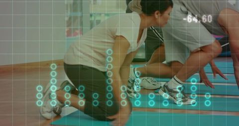Partner fitness class kneeling and crouching workout with digital analytics overlay on studio hardwo