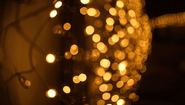 Golden bokeh string lights creating warm ambient glow for holiday and event decor backdrops