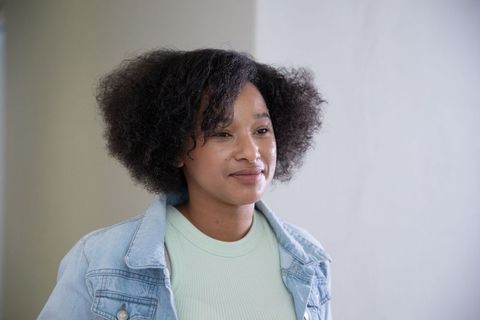 African american woman in minimalist interior with casual attire