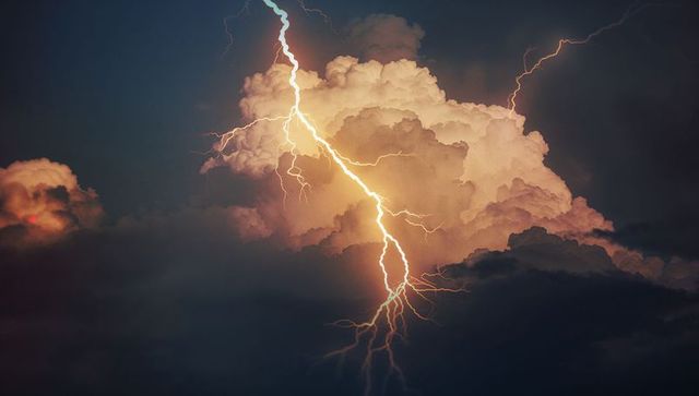Intense lightning bolt in dramatic stormy sky