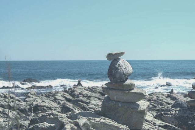 Stone Cairn Balancing on Rocky Beach with Ocean View - Download Free Stock Photos Pikwizard.com