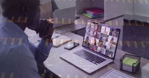 Professional Analyzing Virtual Meeting on Laptop in Office Setting