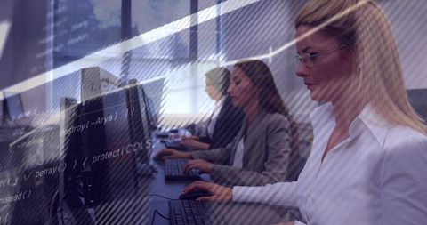 Female Developers Collaborating at Workstations with Code Overlay for Debugging