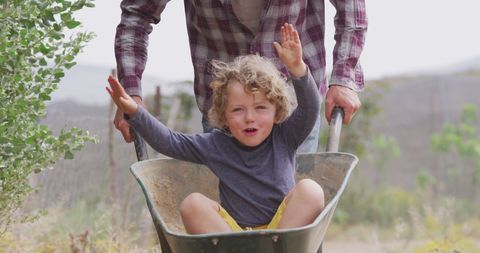 Father and Son Having Fun with Wheelbarrow Outdoors - Download Free Stock Images Pikwizard.com