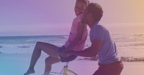 Happy Couple Enjoys Bicycle Ride Along Sunny Beach - Download Free Stock Images Pikwizard.com