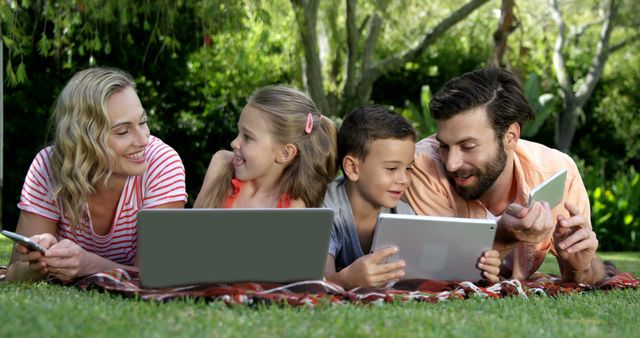 Happy Family Bonding Outdoors Using Gadgets - Download Free Stock Images Pikwizard.com