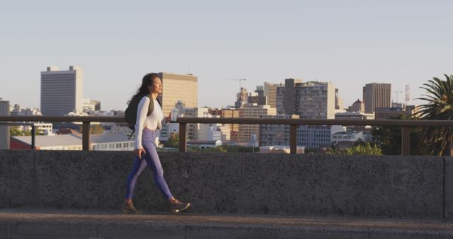 Urban Woman Walking Across City Bridge at Sunset - Download Free Stock Images Pikwizard.com