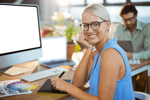 smiling graphic designer using tablet in modern office with transparent screen - Download Free Stock Videos Pikwizard.com