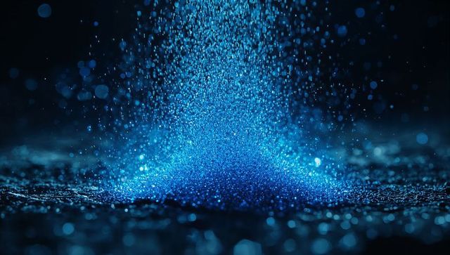 Luminous Blue Particles Cascading onto Reflective Surface
