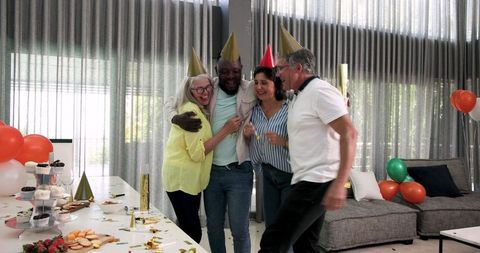 Diverse Coworkers Enjoying Lively Office Celebration
