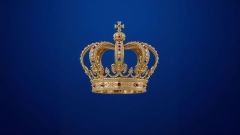 Golden jeweled british empire  crown floating on deep blue background