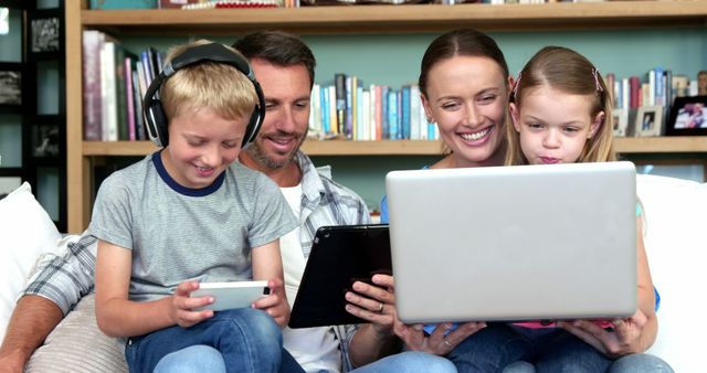 Happy Family Using Devices at Home on Comfortable Couch - Download Free Stock Images Pikwizard.com