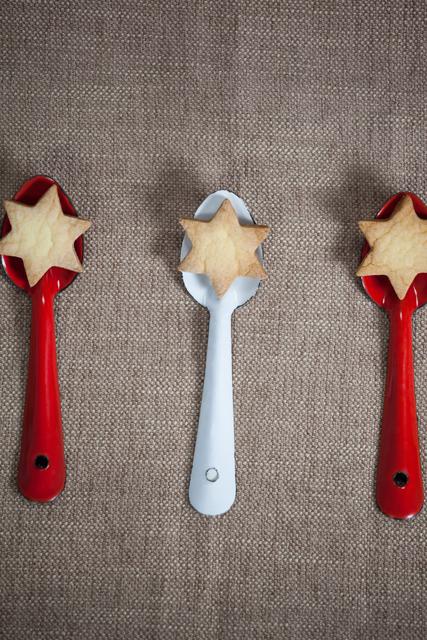 Christmas Star Cookies on Red and White Spoons - Download Free Stock Photos Pikwizard.com