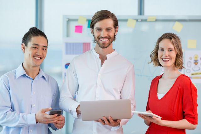 Smiling Business Colleagues Using Technology in Modern Office - Download Free Stock Images Pikwizard.com