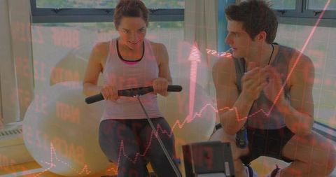 Woman rowing on ergometer while trainer cheering, cardio coaching and fitness motivation