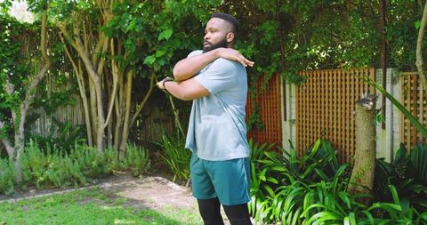 Man stretching outdoors in athletic sportswear