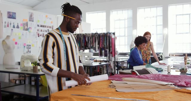 Fashion Designers Working in Studio with Fabrics and Patterns - Download Free Stock Images Pikwizard.com