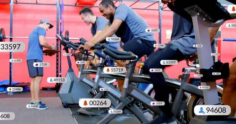 Indoor cycling class pedaling with social media badges and fitness tracking overlays